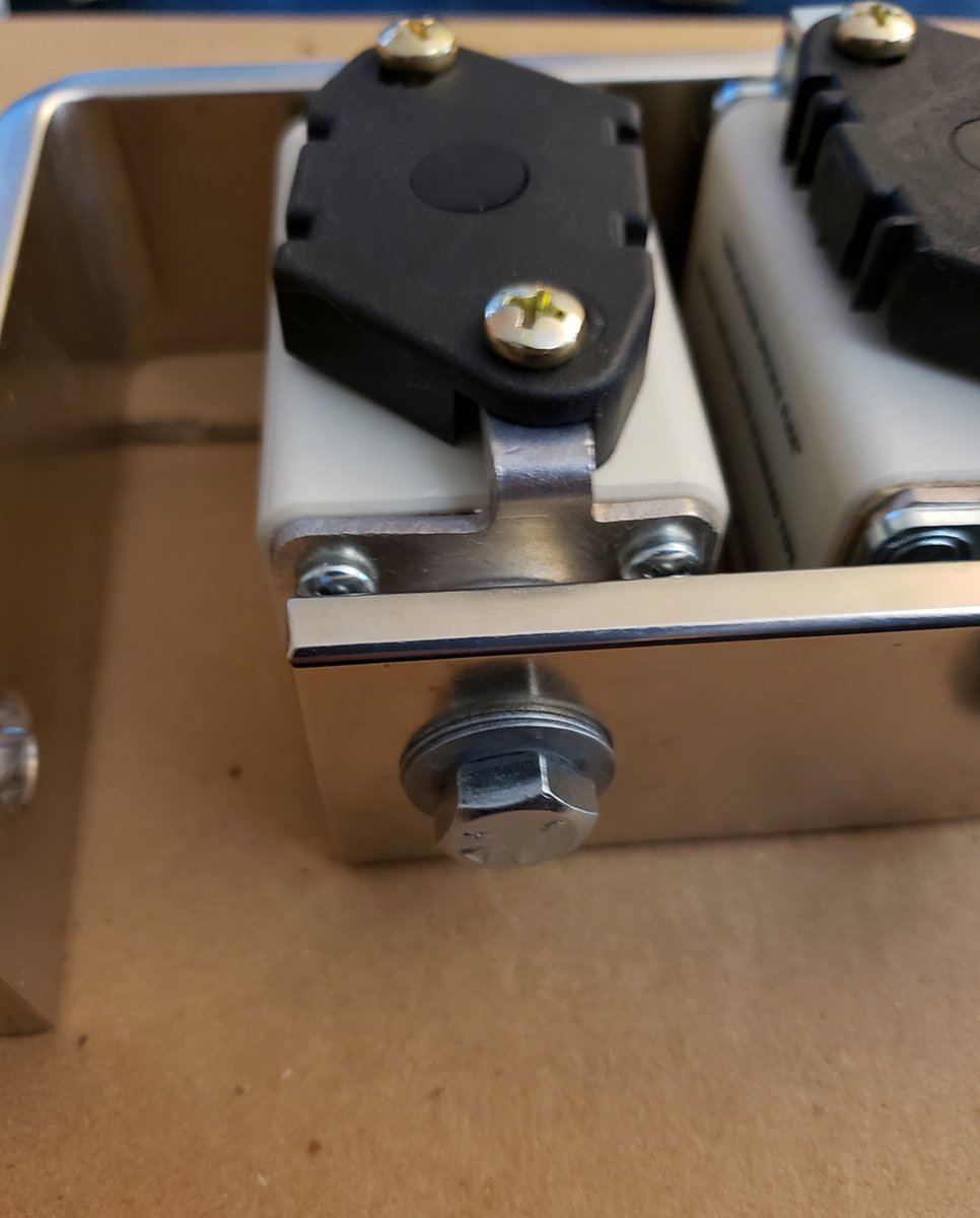 Close detail of the microswitch bracket mounted to a fuse end cap