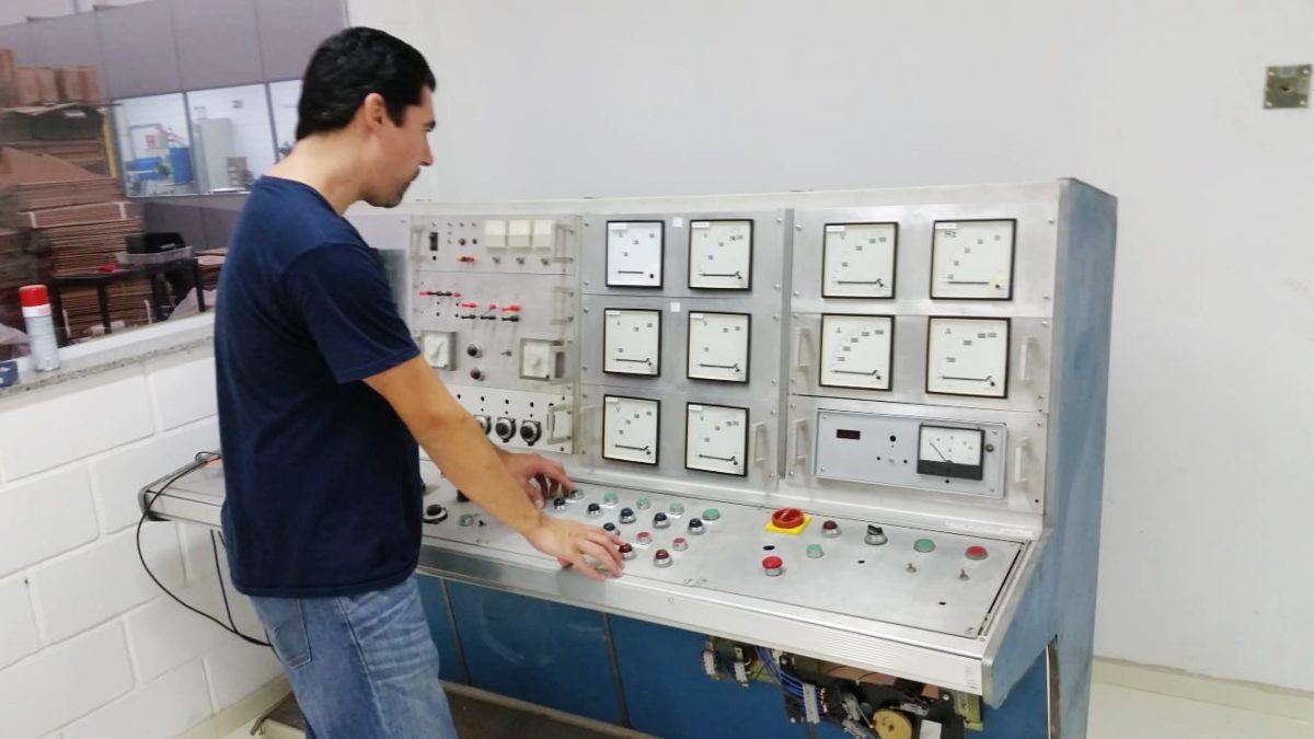 A technician operating the laboratory control panel
